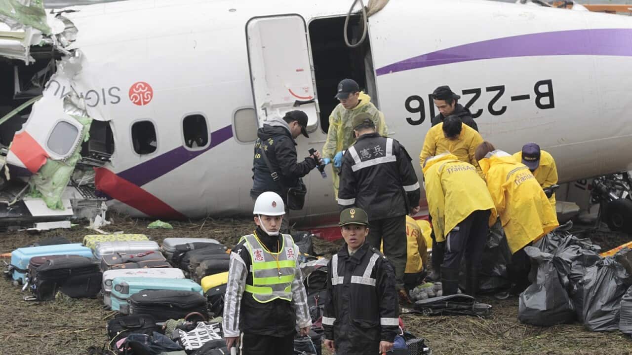 TransAsia Airways Flight 235 with 58 people aboard clipped a bridge shortly after takeoff and crashed into a river in the island's capital of Taipei. (AP/Wally Santana)