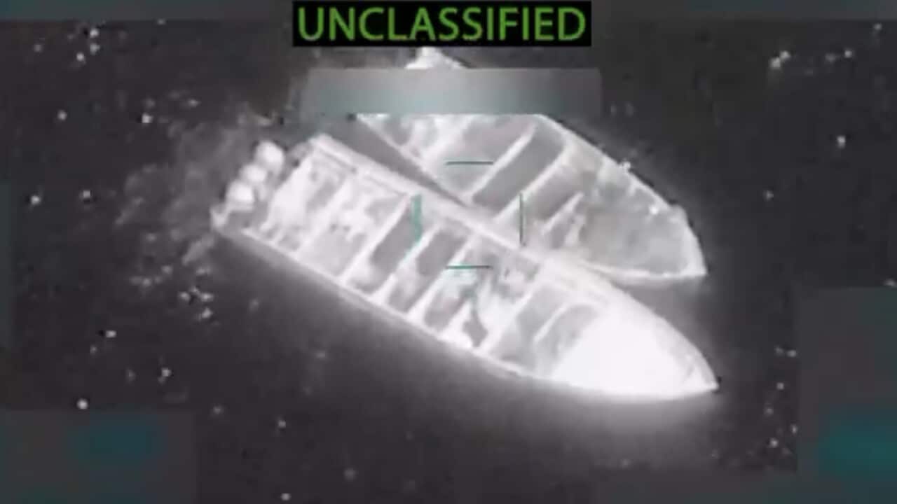 A screen grab of an aerial image of two boats huddled together in water, with the word unclassified written on top.