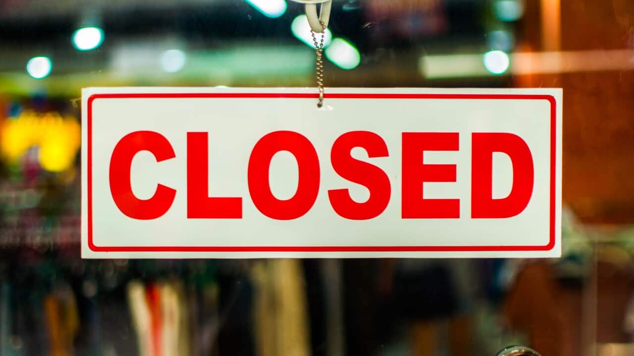 A glass door with "closed" store sign