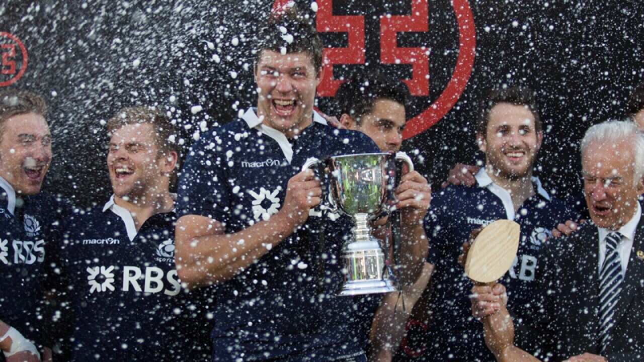 Scotland's lock Grant Gilchrist (C) holds the ICBC Cup