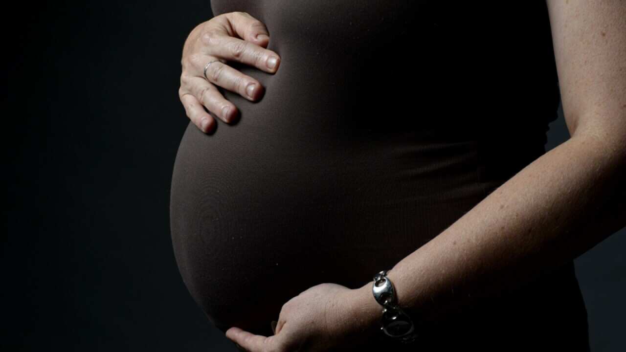 A woman eight months into her pregnancy