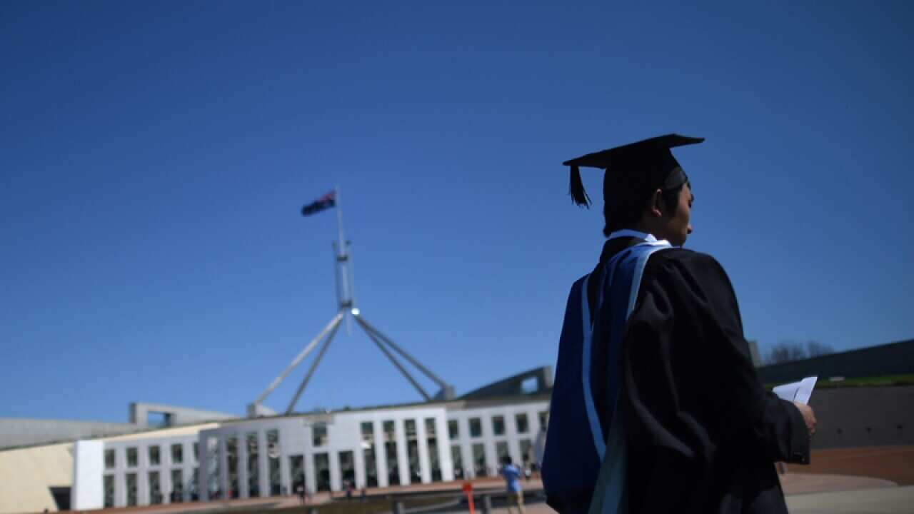 A university graduate outside Parliament House in Canberra