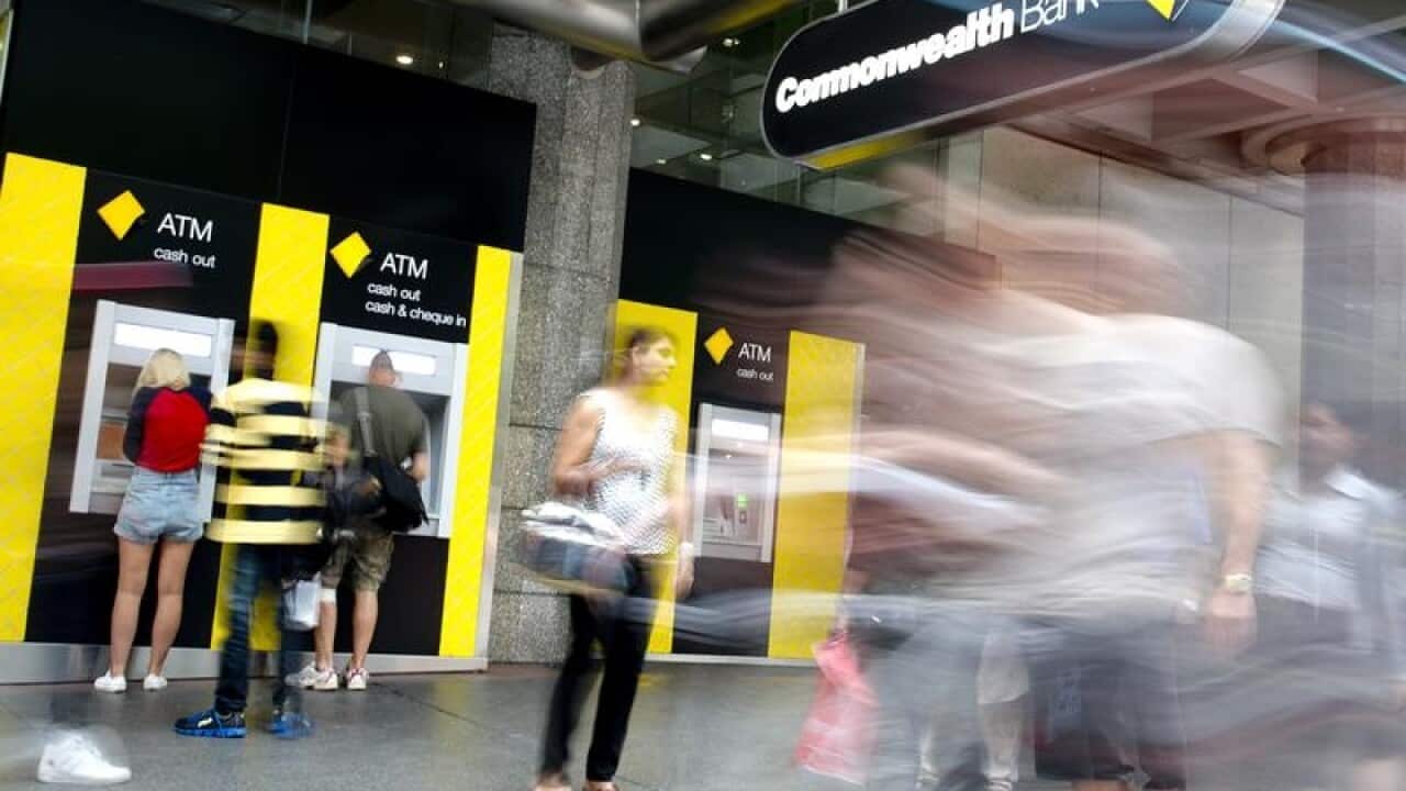 street scene showing people at CBA ATM