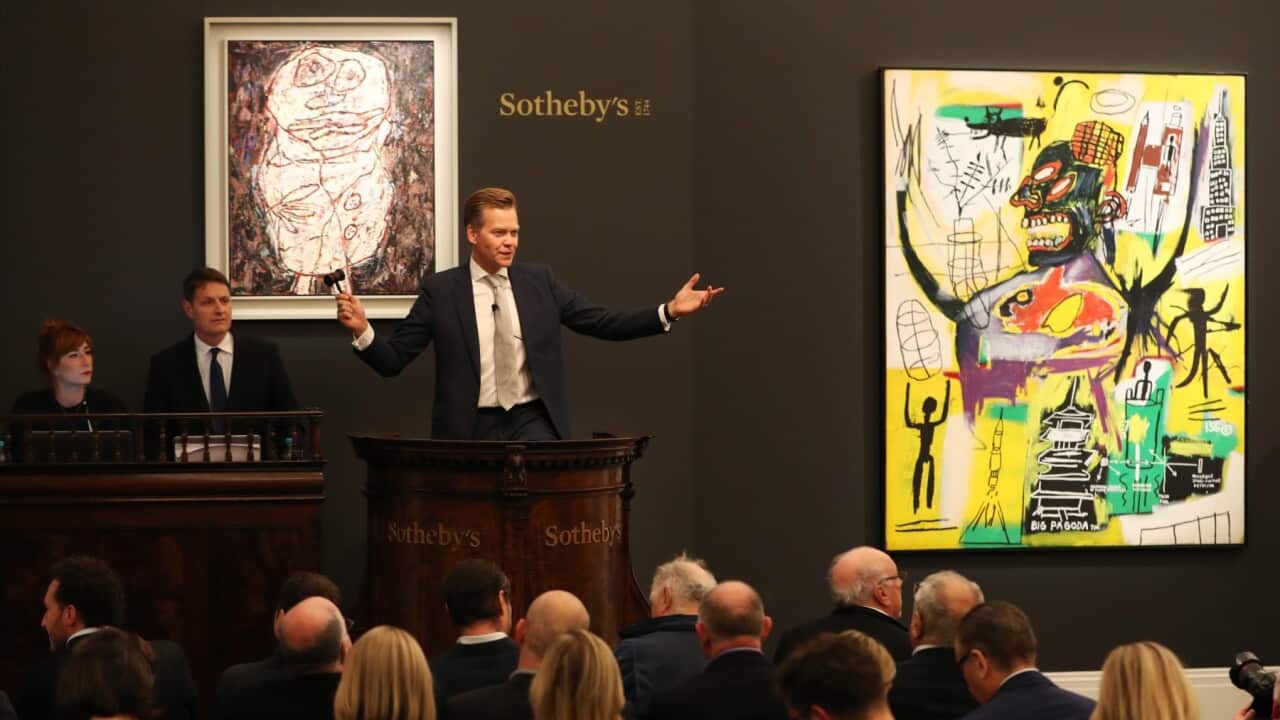 Sotheby’s European Chairman, Oliver Barker, brings the hammer down on Banksy’s record-breaking dystopian view of The House of Commons overrun with Parliamentary primates (not pictured) on October 03, 2019 in London, England.