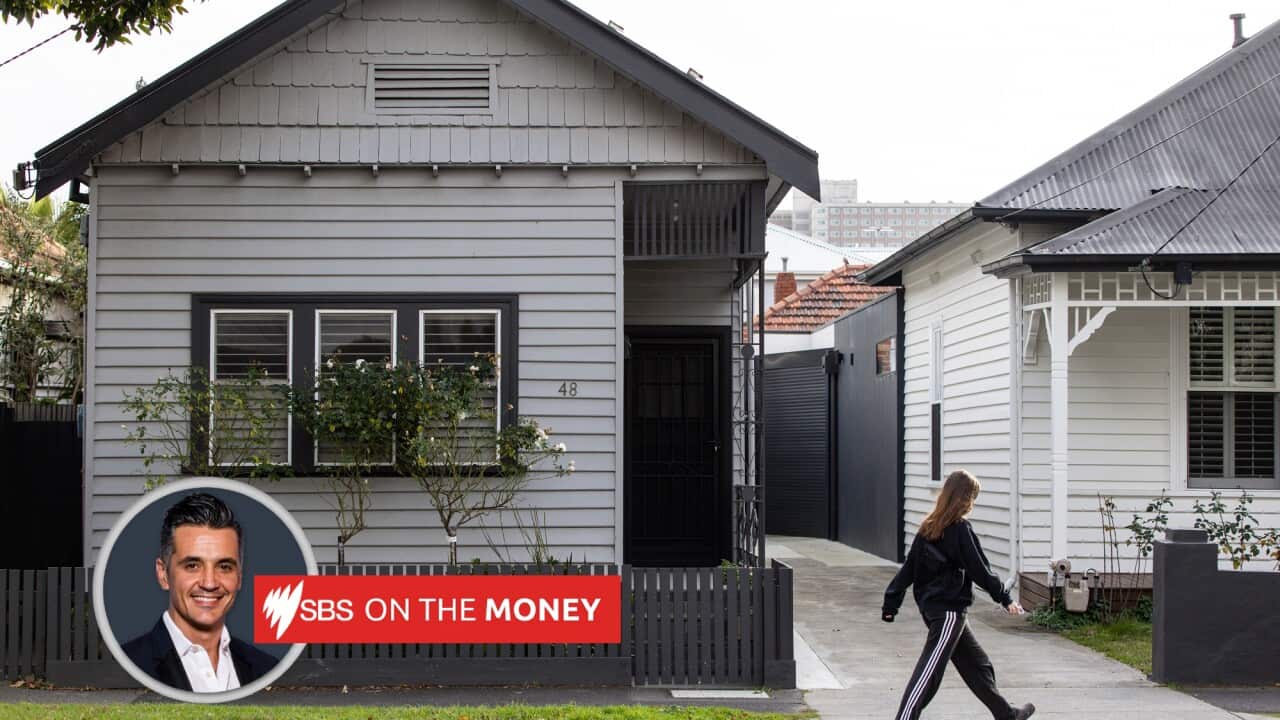 A person walks by a house in Melbourne.