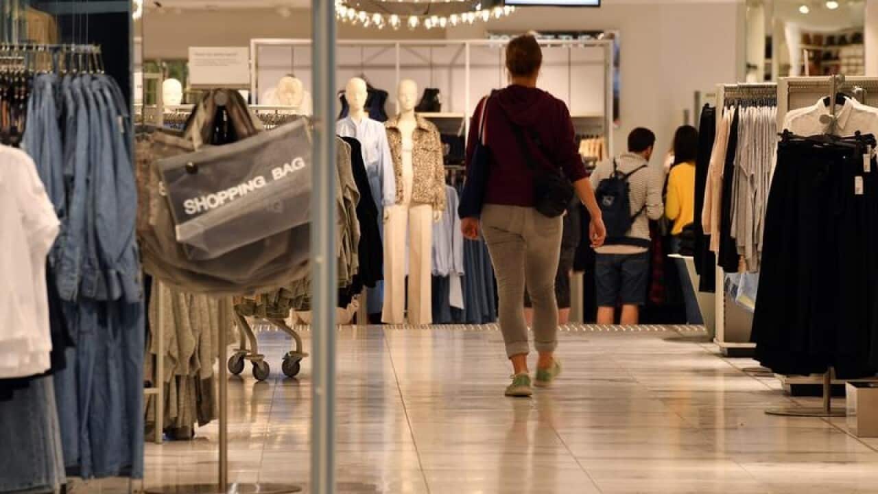 A shopper walks into a women's fashion store in Sydney.