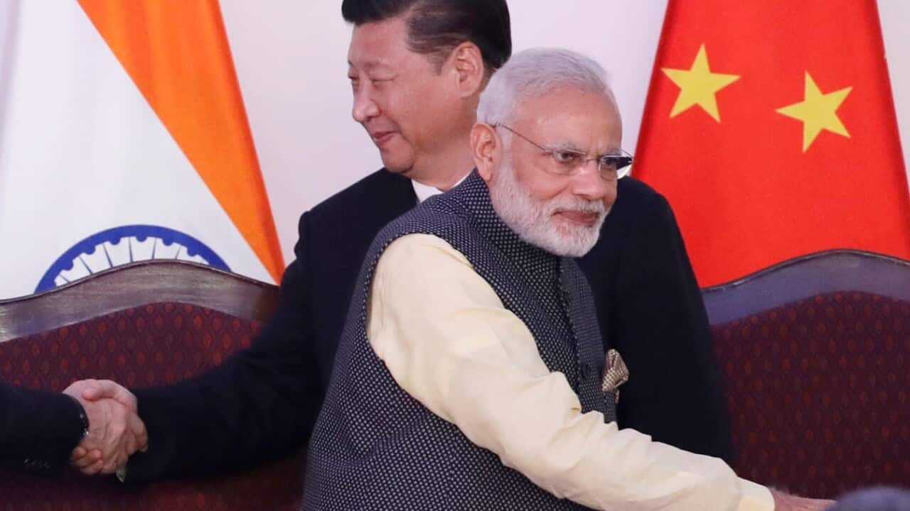 In this Oct. 16, 2016, file photo, Indian Prime Minister Narendra Modi, left, talks with Chinese President Xi Jinping