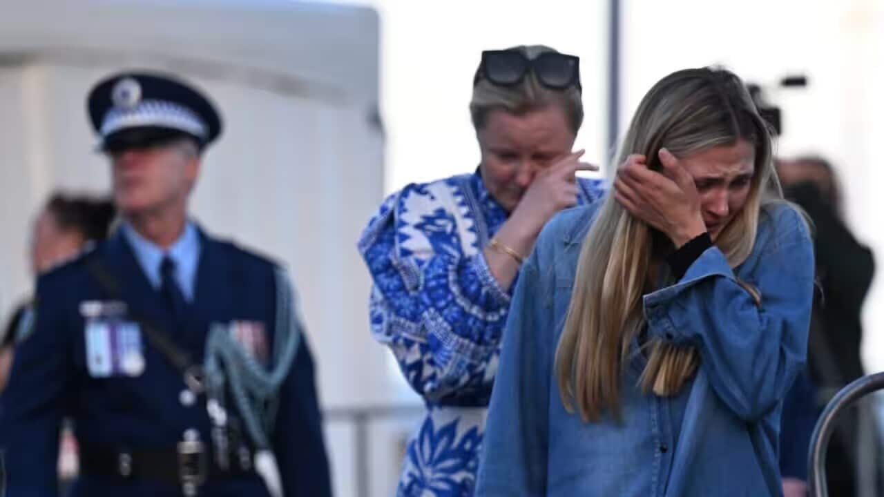 Mourners during a candlelight vigil to honour the victims of the Bondi Junction tragedy at Bondi Beach in Sydney on Sunday AAP - Dean Lewins.jpg
