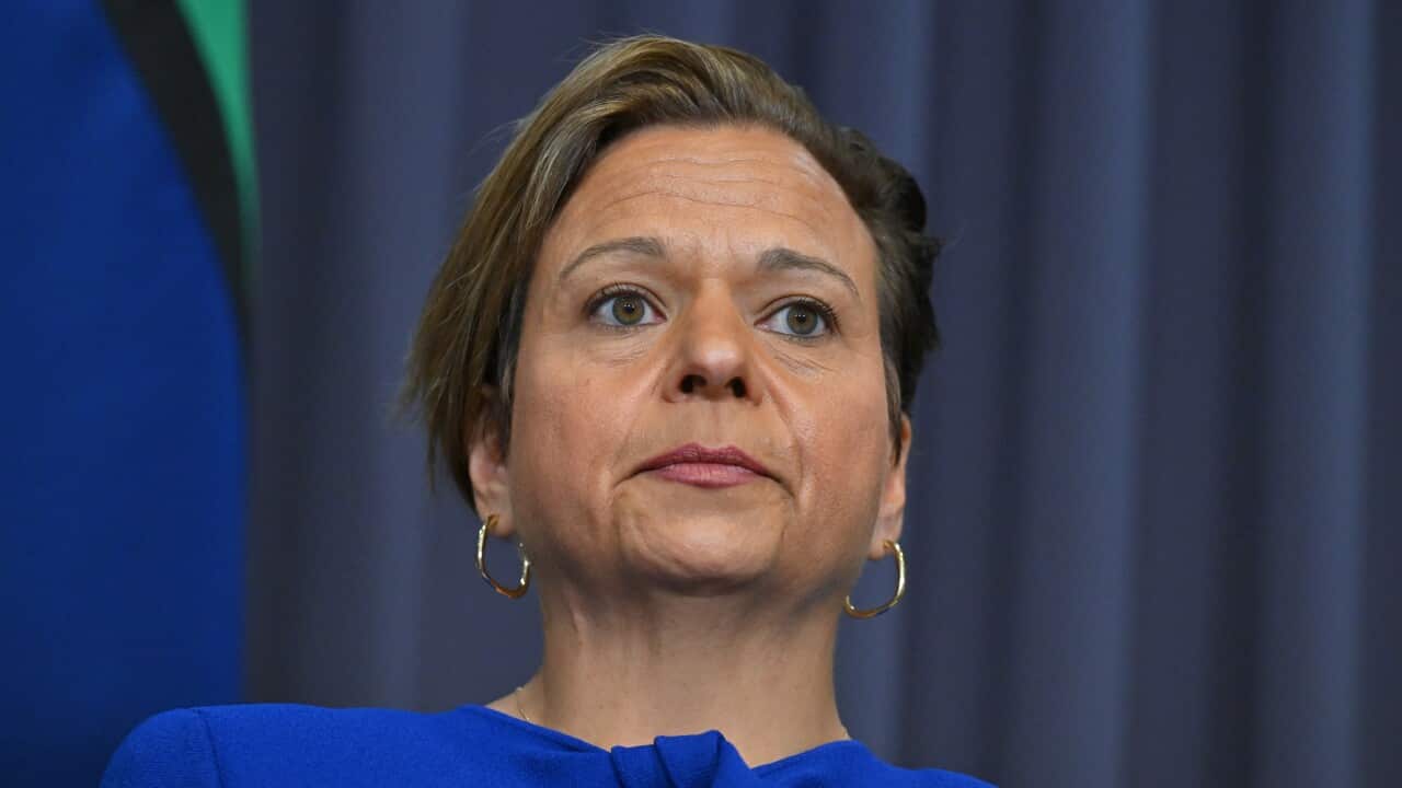 A woman with short hair and a blue top