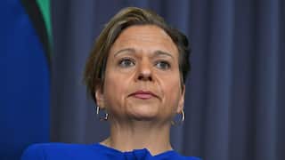 A woman with short hair and a blue top