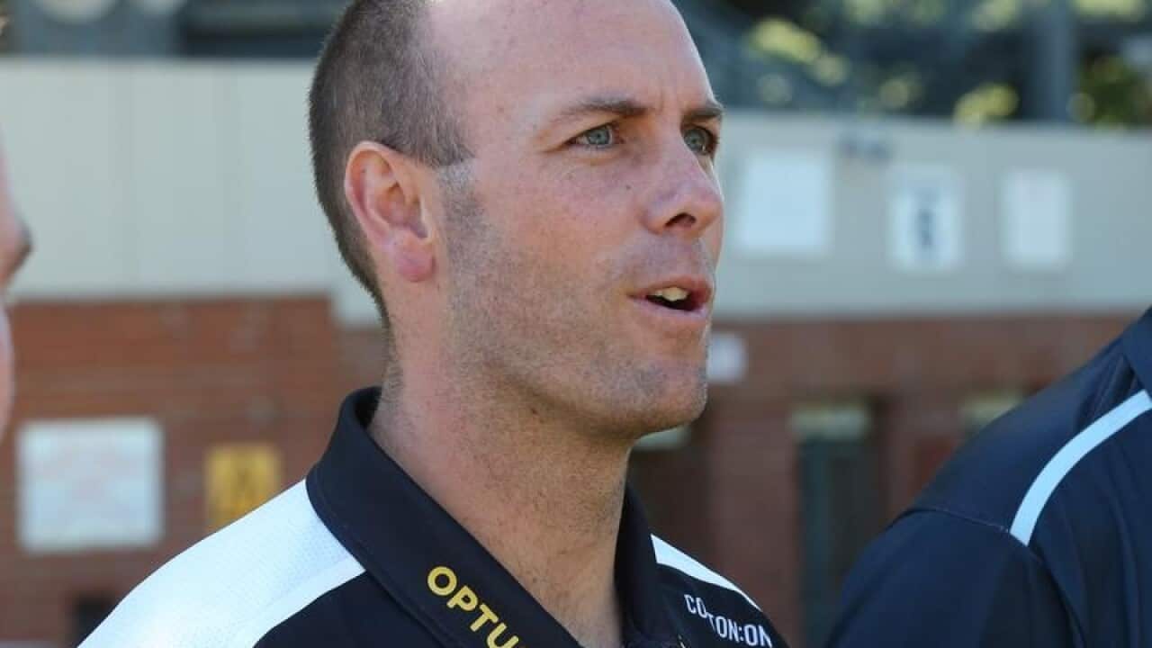 Collingwood women's coach Wayne Siekman speaks at a press conference.