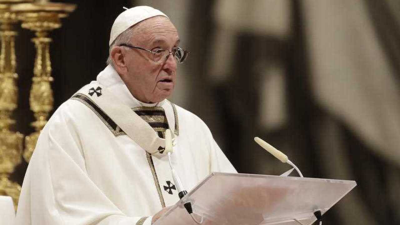 Pope Francis delivers his message as he celebrates the Christmas Eve Mass in St. Peter's Basilica at the Vatican.