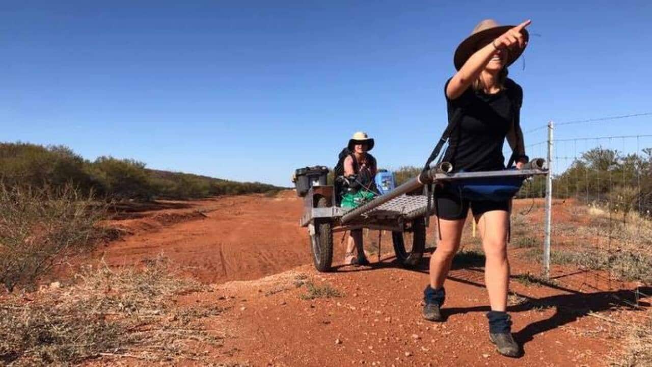 Sarah hyde walking the Rabbit Proof Fence