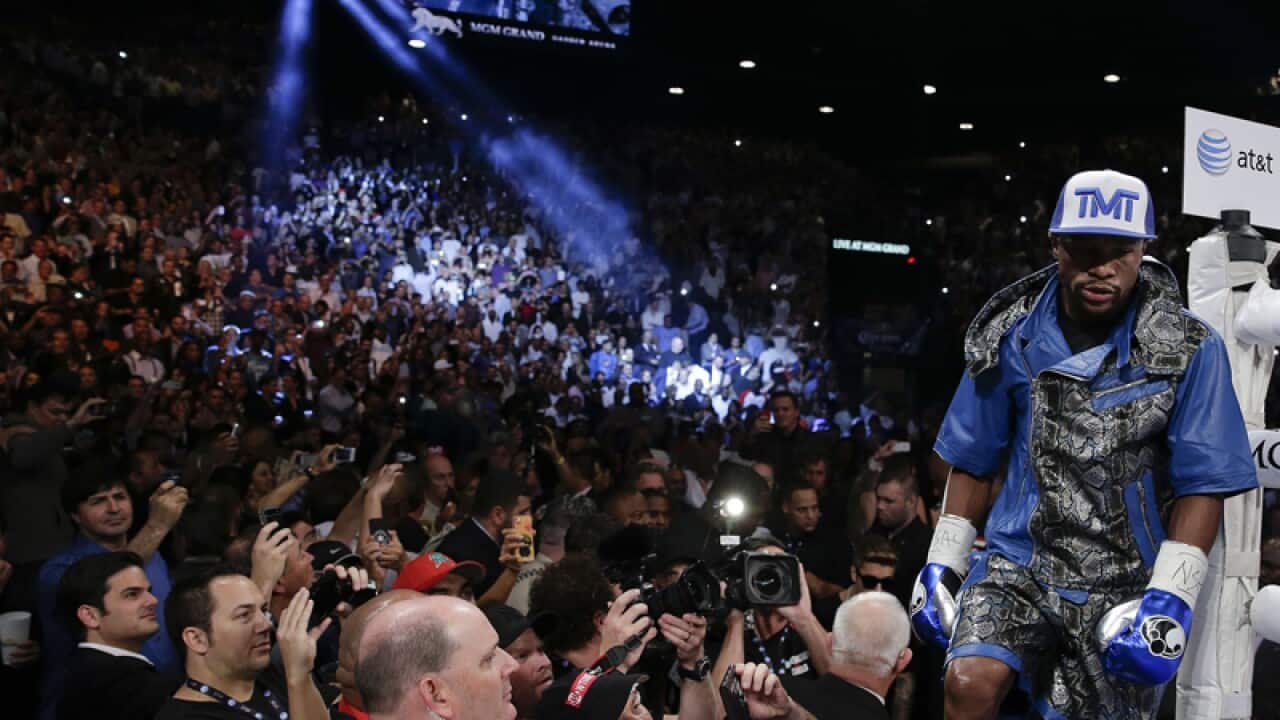Floyd Mayweather Jr. steps into the ring