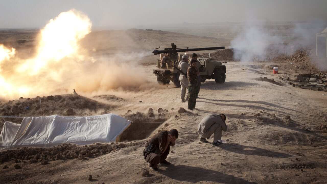 Kurdish Peshmerga fighters fire cannon towards Islamic State positions - AAP-001.jpg