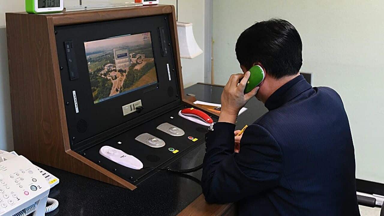 In this handout image, a South Korean government official checks the direct communications hotline to talk with North Korea.