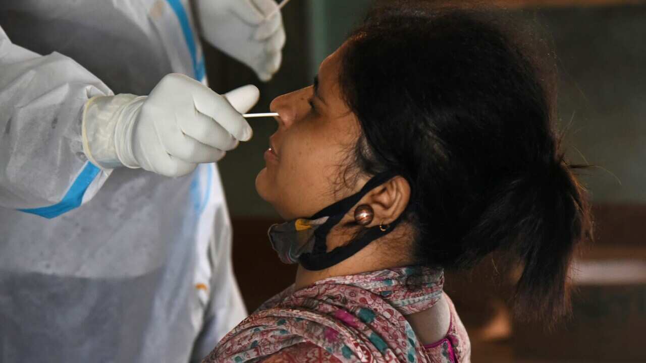 Indian Health workers take swab samples for COVID-19 testing, in Guwahati, India
