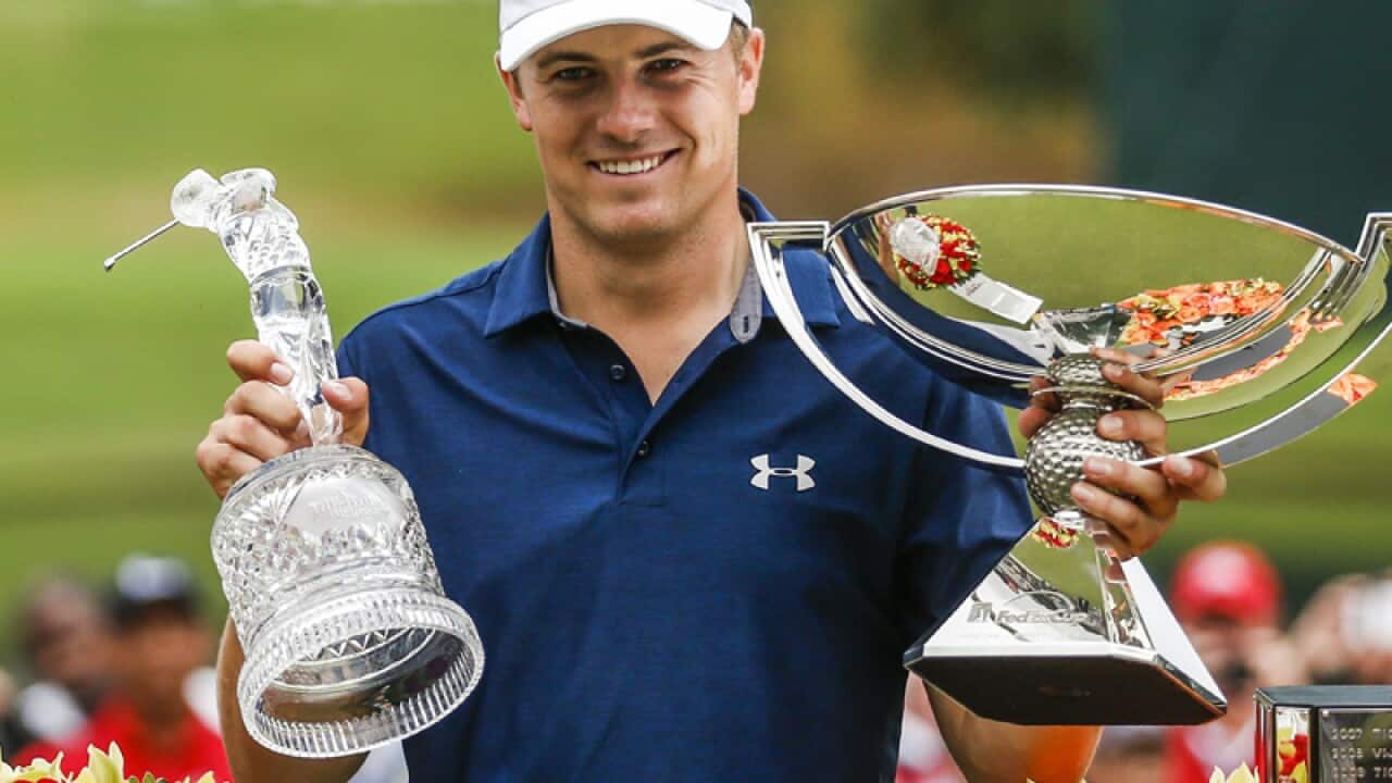 Jordan Spieth lifts the TOUR Championship trophy