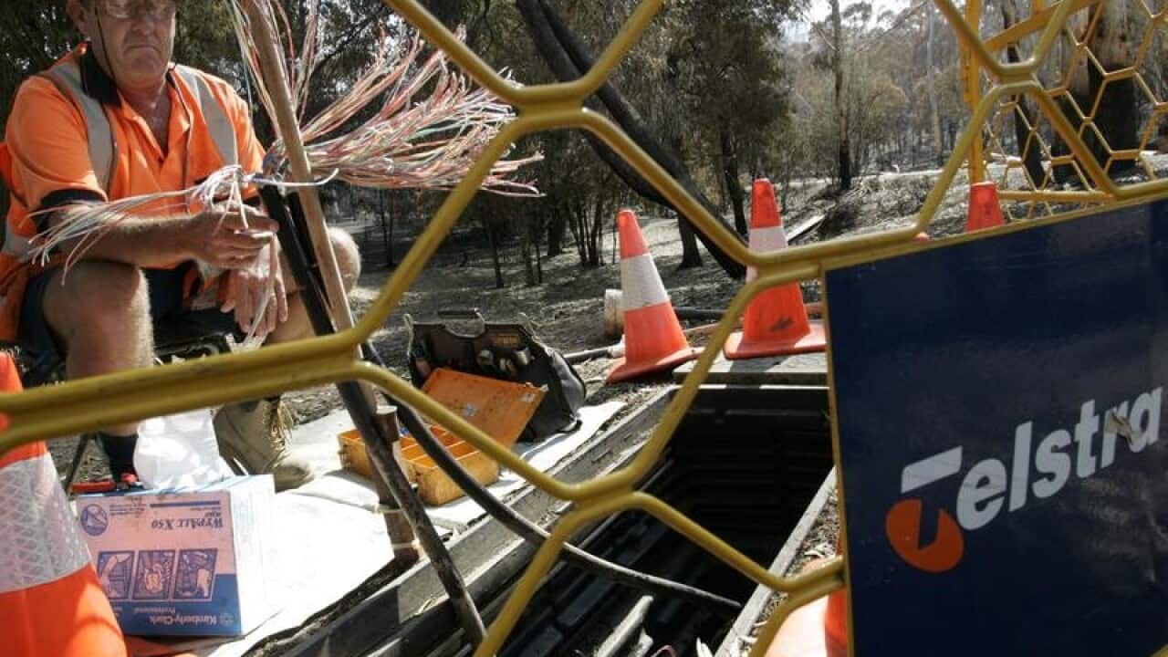 Telstra technician works on the NBN.