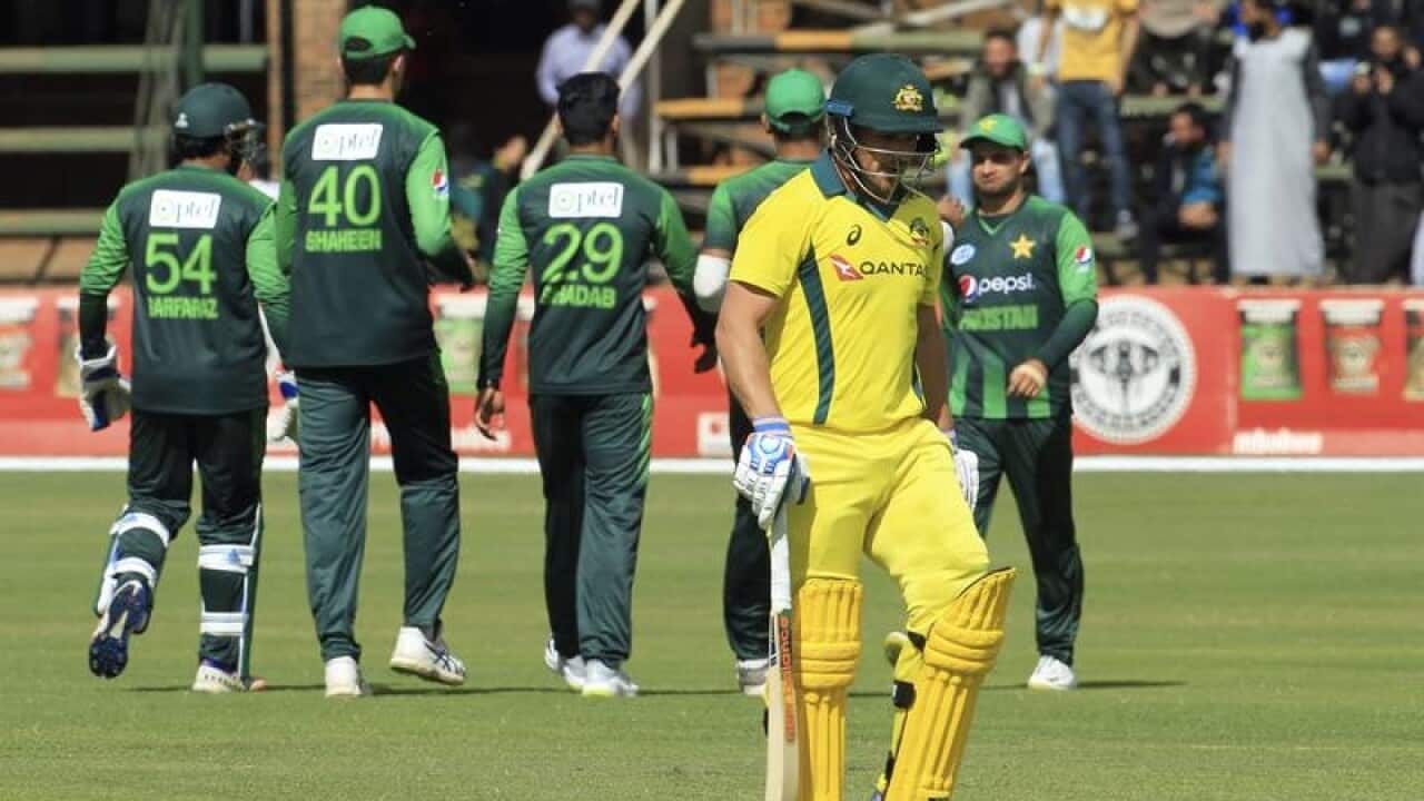 Australian captain Aaron Finch (C) leaves the pitch