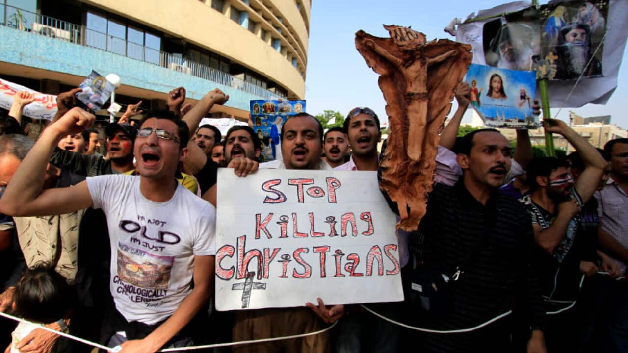 In this May 19, 2011 file photo, Egyptian Coptic Christians chant angry slogans as they protest the recent attacks on Christians and churches
