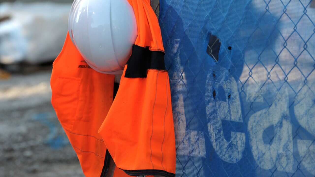 A hard hat and a high visibility vest at a building site in Brisbane