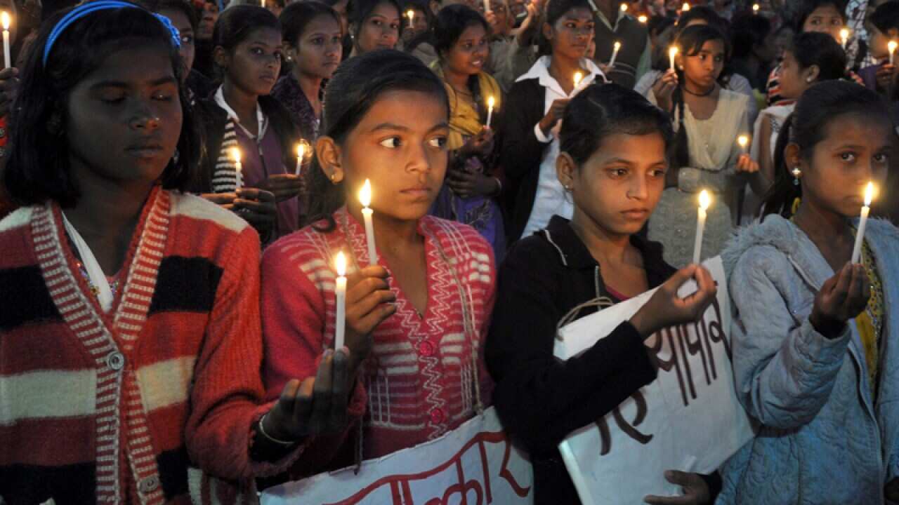 Indian women girls light candles to pay tribute to a gang rape victim