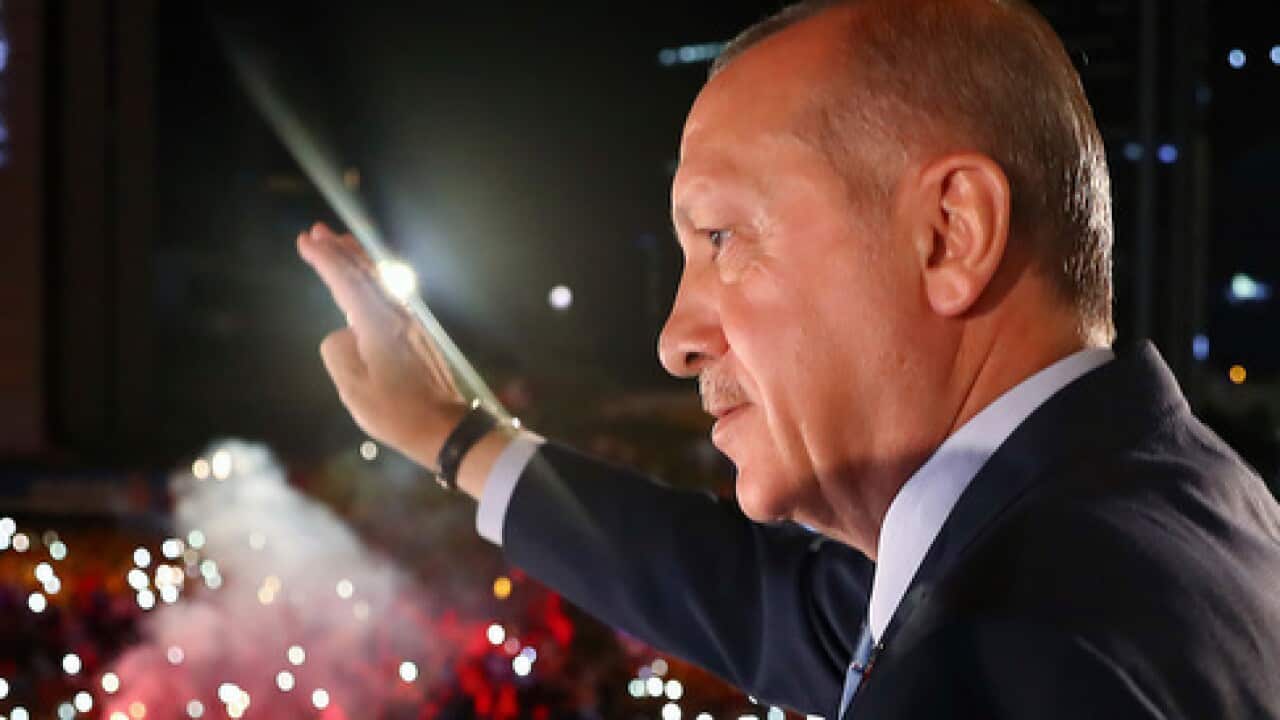 Recep Tayyip Erdogan waves to celebrating supporters