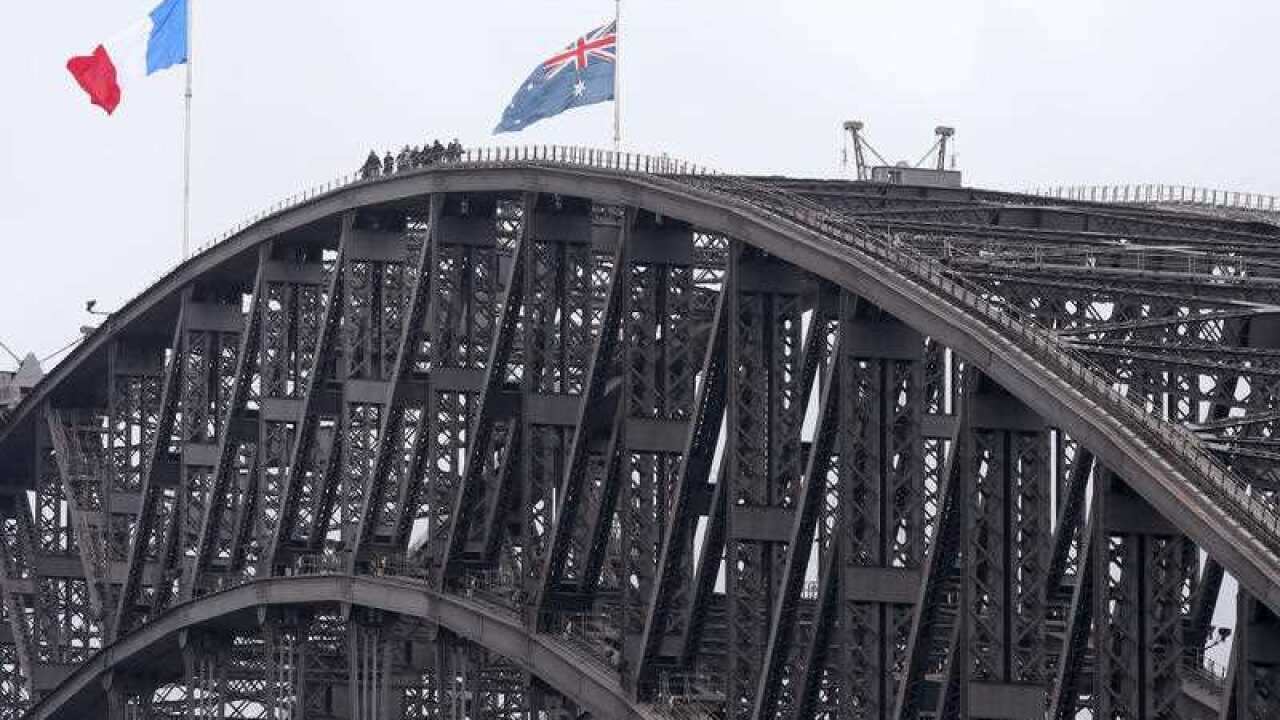 French flag flies alongside an Australian flag in Sydney