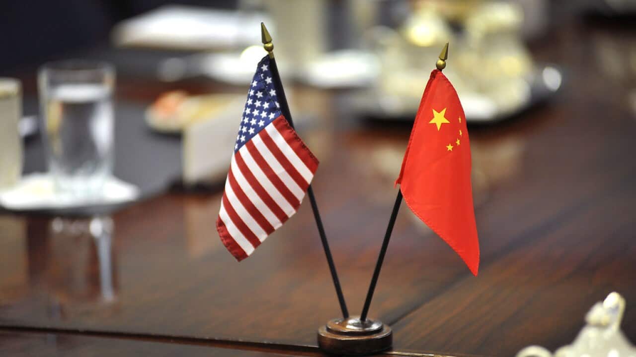 US & China Flags on negotiation table