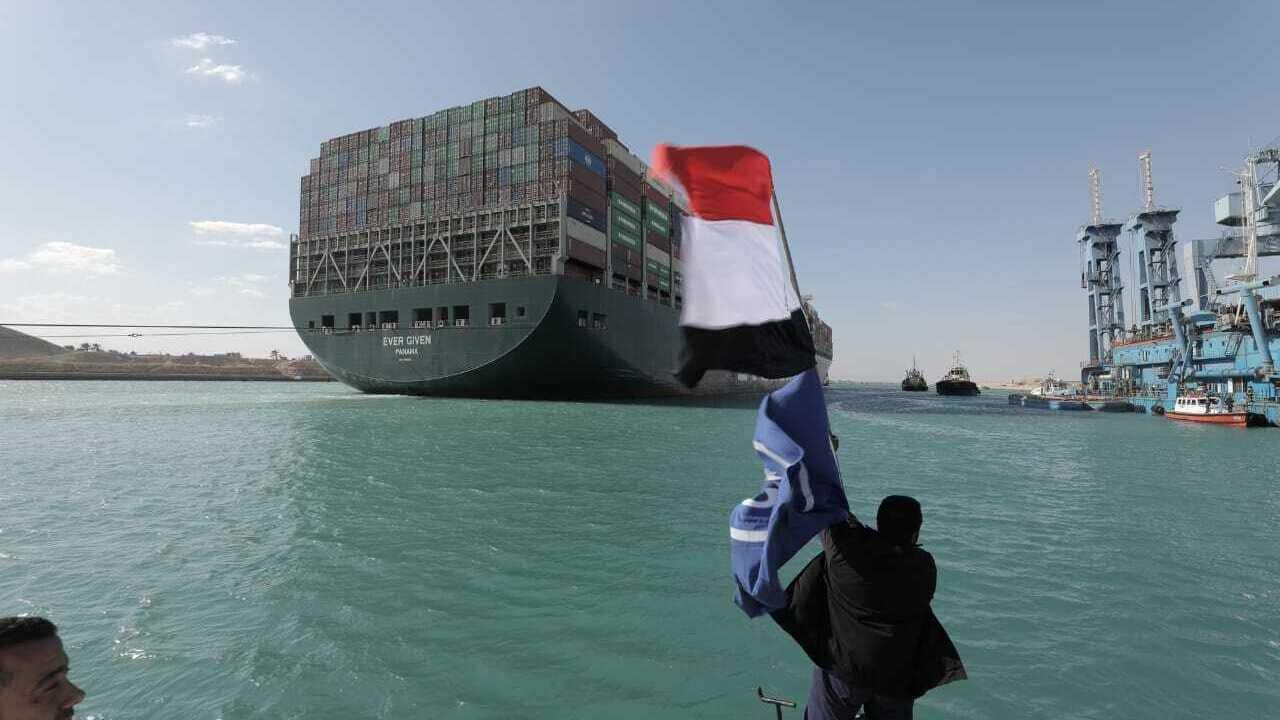 Ever Given cargo ship is accompanied by Suez Canal tugboats as it moves in the Suez Canal, Egypt, on 29 March 2021. 