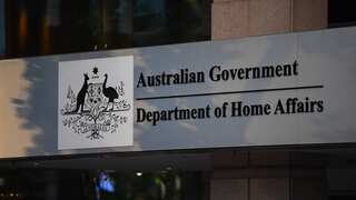 A sign on a building that reads: Australian Government: Department of Home Affairs