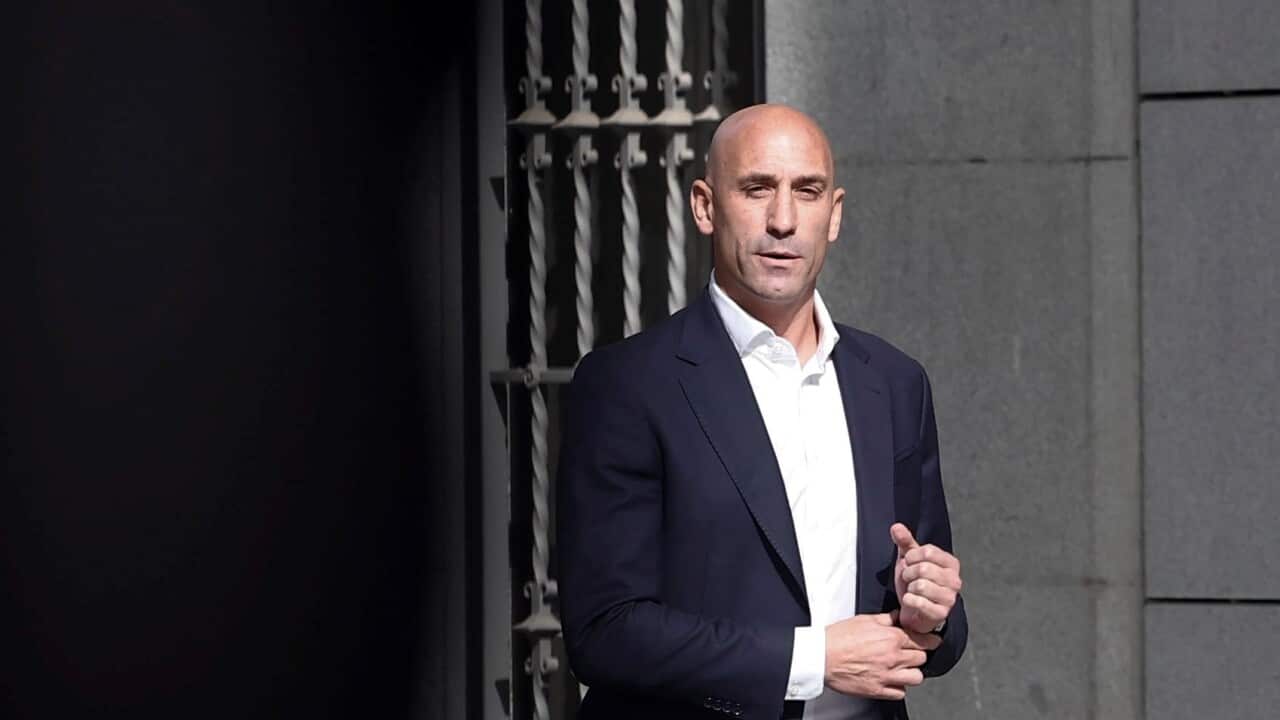 Luis Rubiales wearing a suit standing outside a building