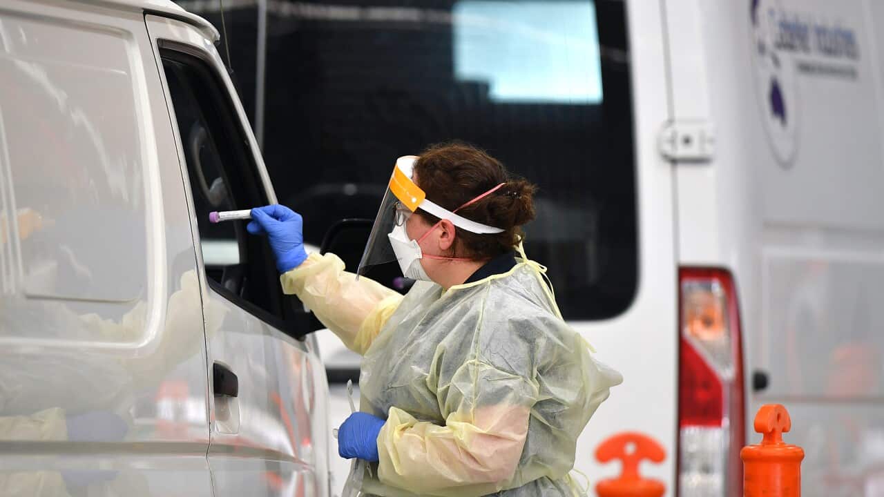 A healthcare worker takes a sample for a COVID-19 test.