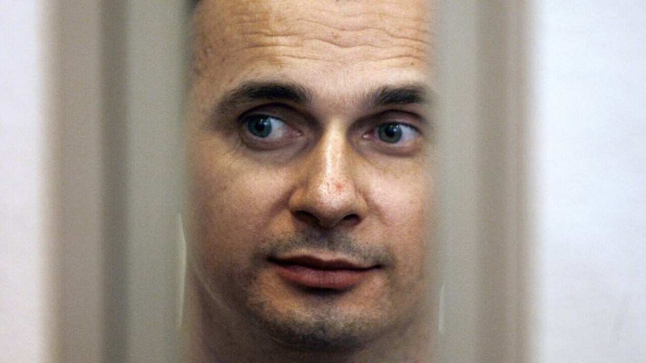 Ukrainian film director Oleg Sentsov inside of the defendant's cage in a military courtroom.