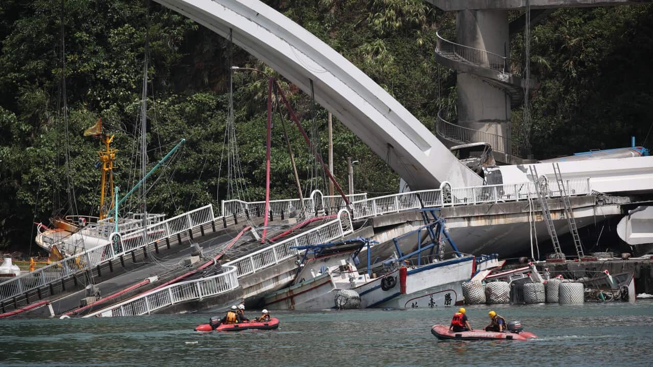 Rescuers conduct an inspection at the collapsed Nanfangao Bridge.