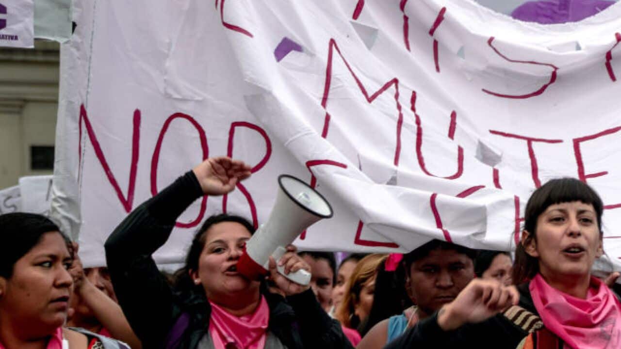 Women chant slogans and sing songs during the protest.