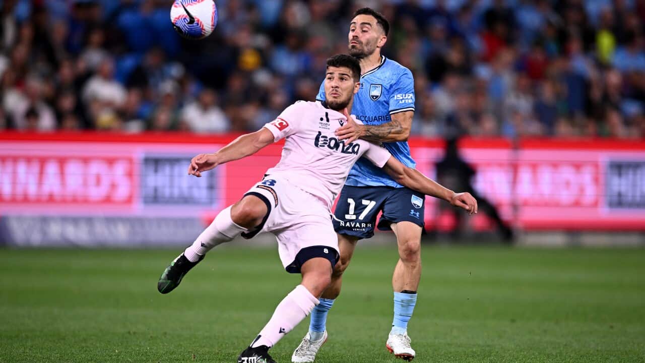 Melbourne Victory's Zinedine Machach competes for the ball with Anthony Caceres of Sydney during the A-League Men in Sydney