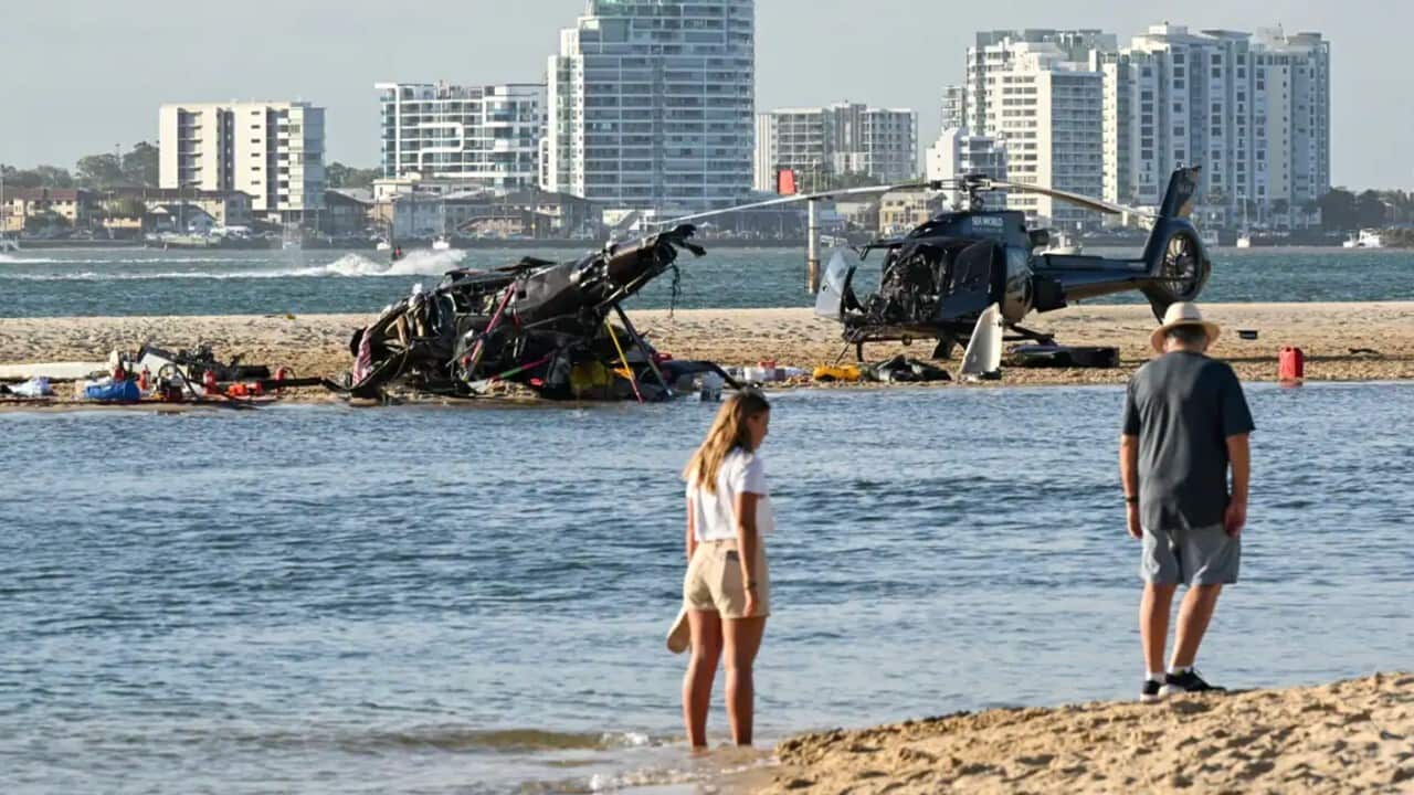 A collision between two helicopters on Gold Coast killed four people and injured 13 others.jpg