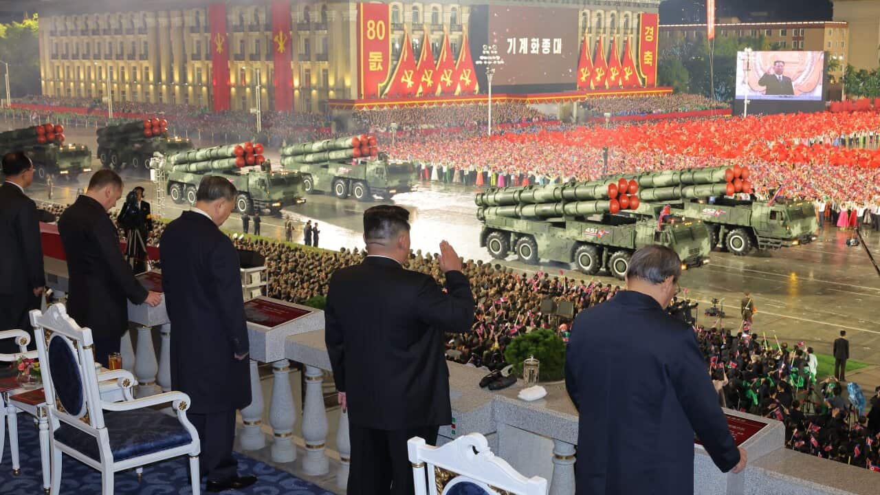 North Korean leader Kim Jong Un looks over a military parade.
