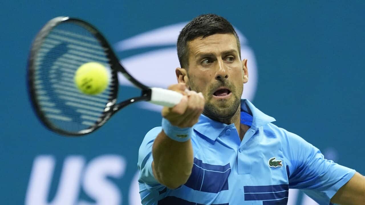 Novak Djokovic, of Serbia, returns a shot to Radu Albot, of Moldova, during a first round match of the U.S. Open tennis championships