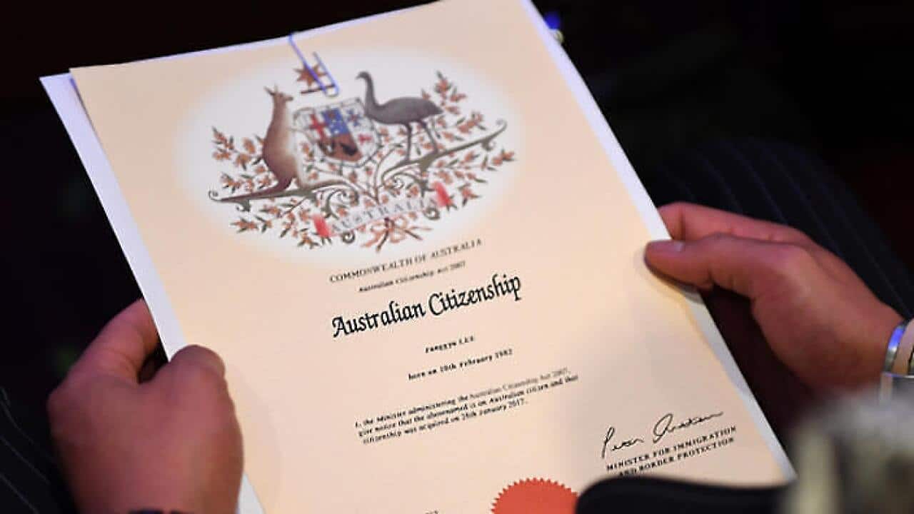 An Australian citizenship recipient holds his certificate.