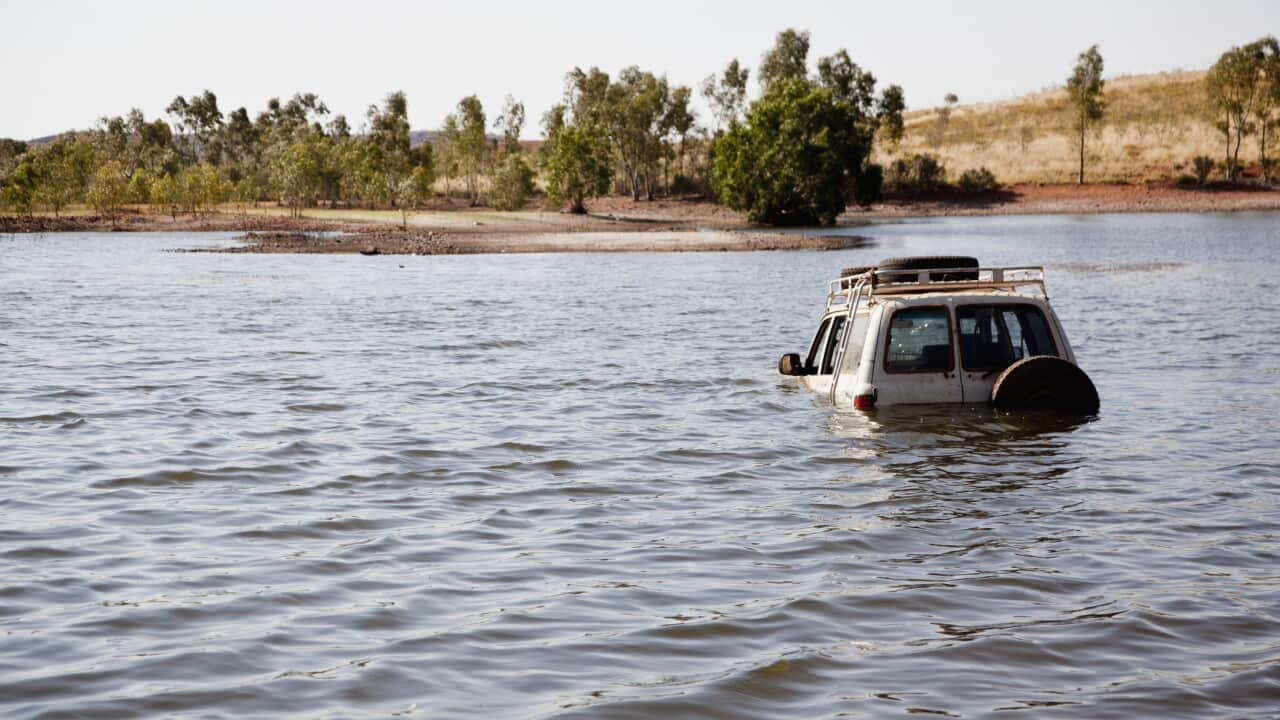 A 4x4 driving through deep water