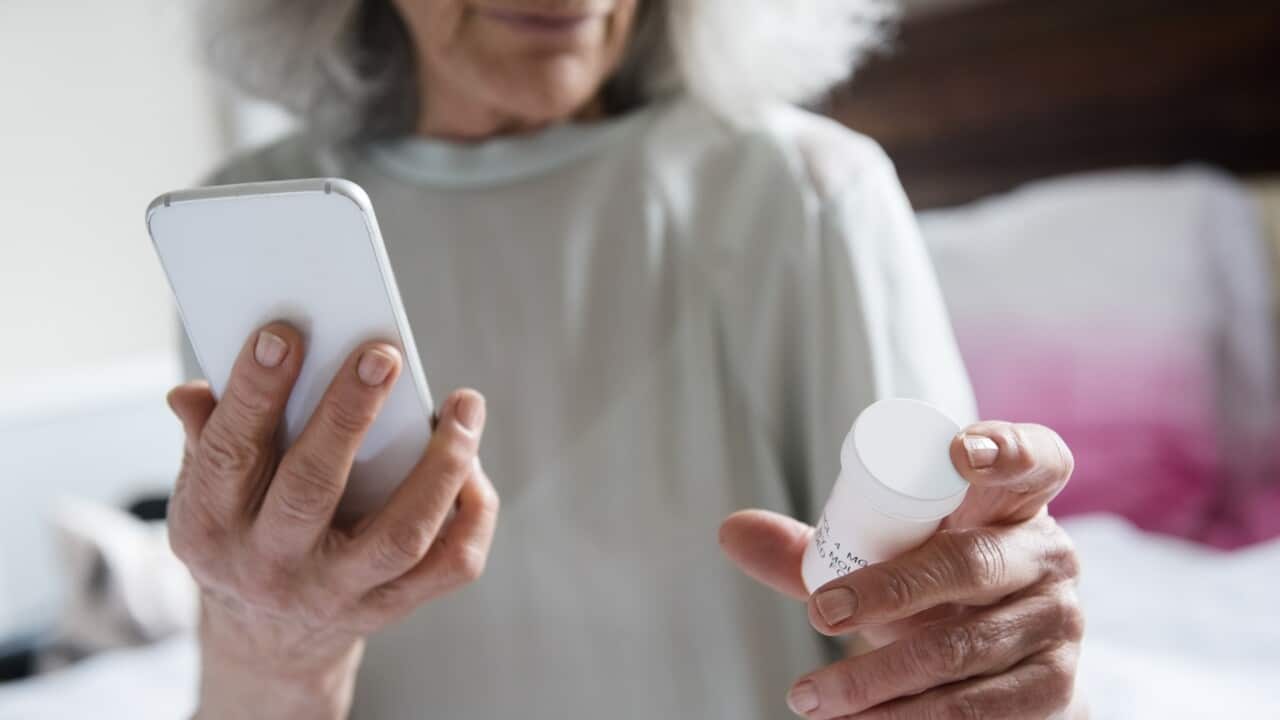 Older woman checking prescription
