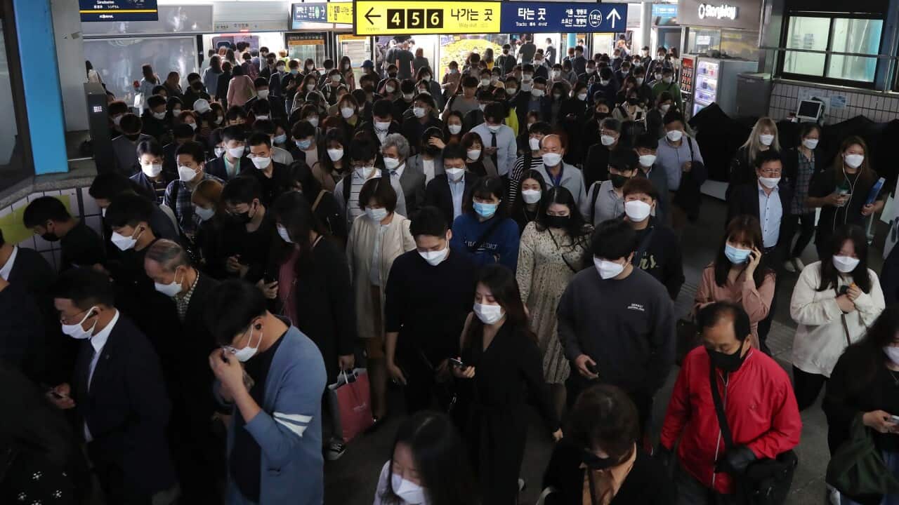 Commuters wearing masks