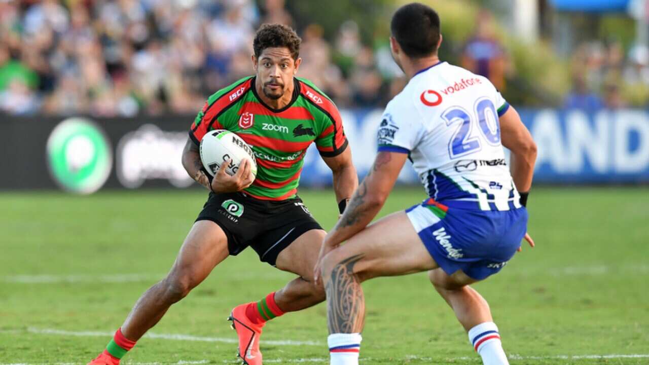 A woman holds an Australian Aboriginal Flag (AAP)