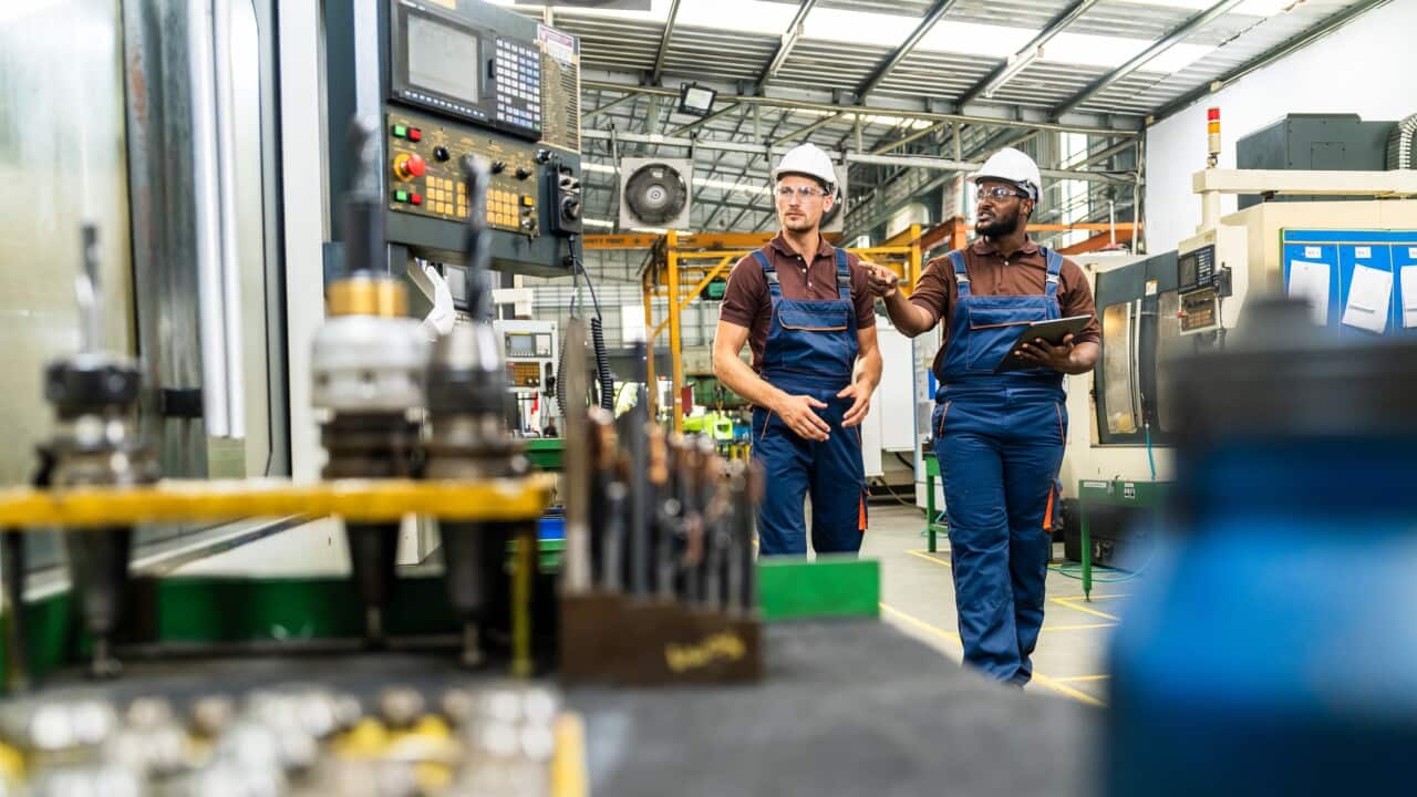 Industrial Engineers Collaborating in Modern Manufacturing Facility