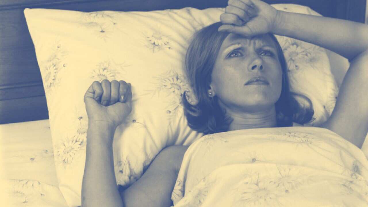Close-Up Woman Lying In Bed With Pained Expression