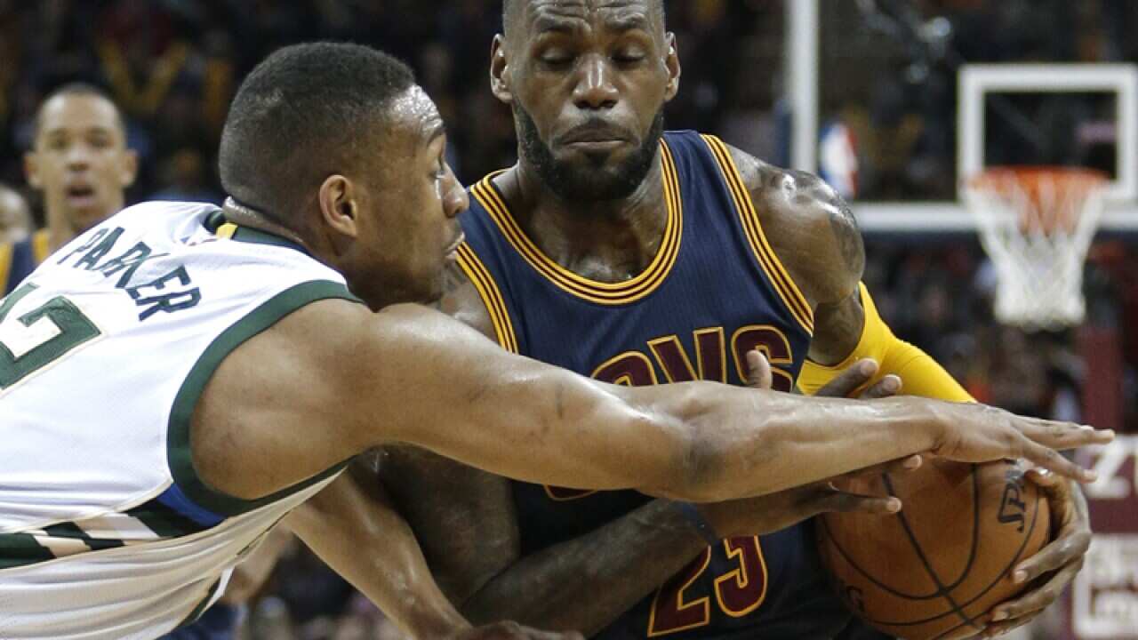 Bucks' Jabari Parker (L) fouls Cavaliers' LeBron James