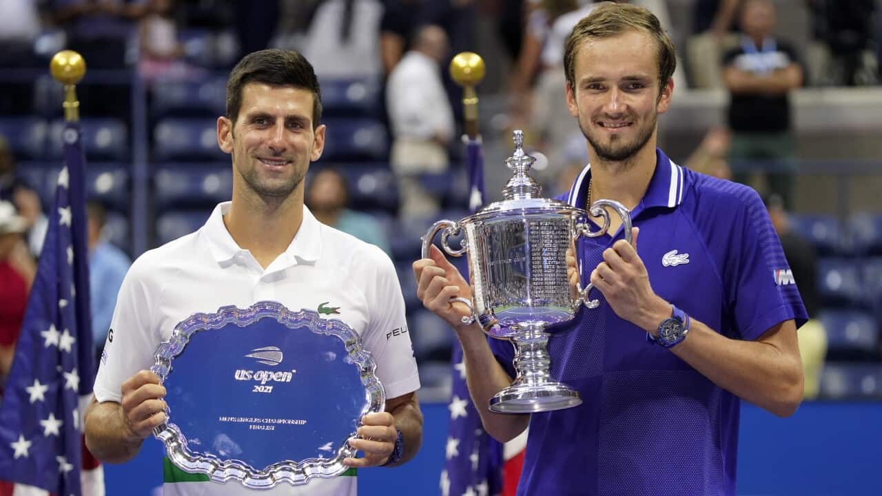 Daniil Medvedev, of Russia, right, and Novak Djokovic, of Serbia, pose for photos after Medvedev defeated Djokovic in the men's singles final of the US Open tennis championships, Sunday, Sept. 12, 2021, in New York. (AP Photo/John Minchillo)